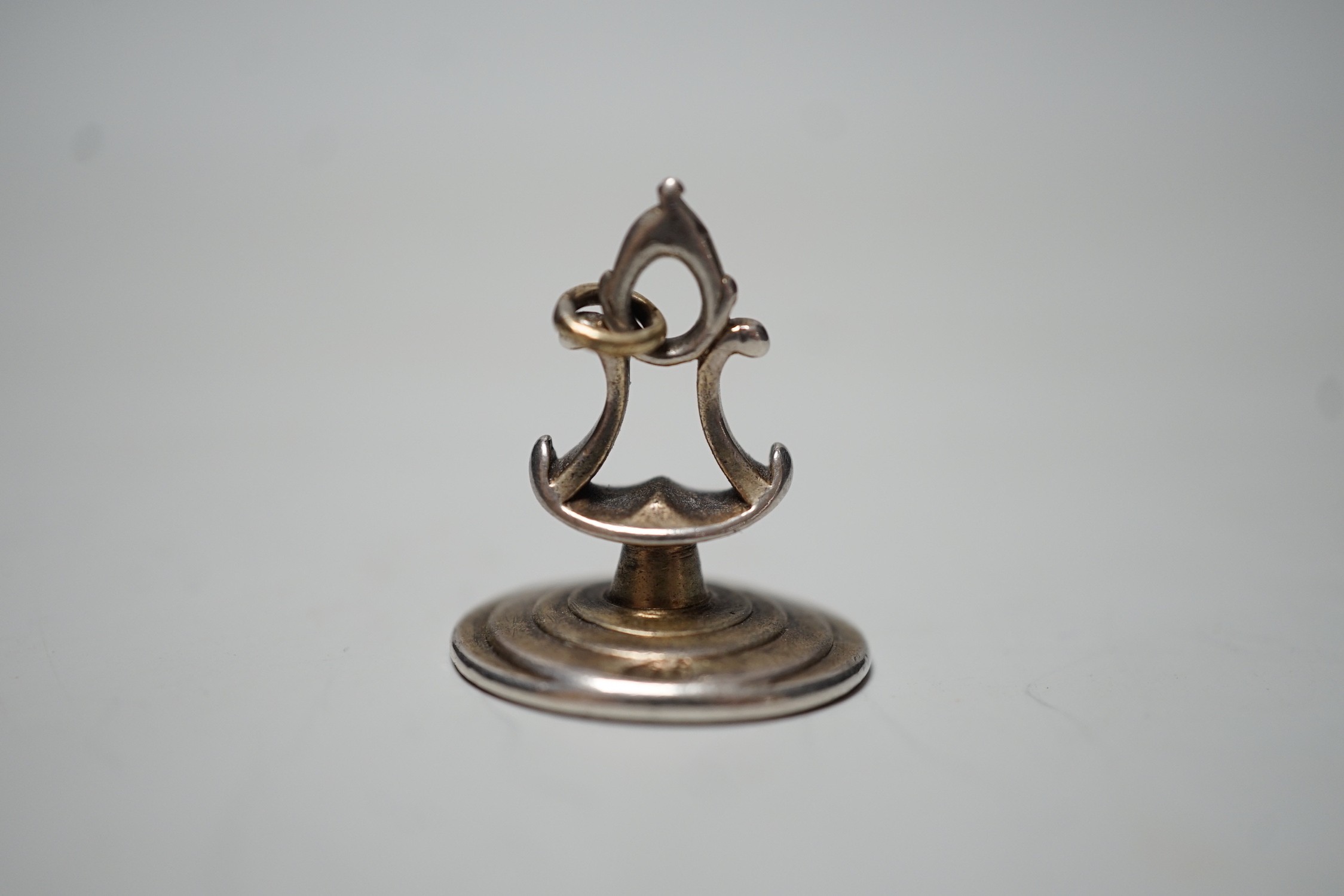 A George III silver fob seal, the matrix engraved with monogram below a crest, indistinct maker's mark ?B, 25mm.